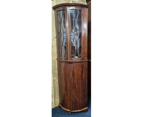 19th century Mahogany bow front corner cabinet. Top section having bow glass doors. brass trim and comes with key. Bottom sec