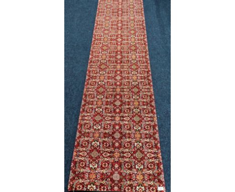 A Large hall runner rug. Red Ground. [773x69cm] 
