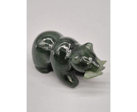 Hand carved jade sculpture of a bear holding a fish in its mouth. [5cm length] 