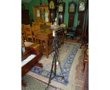 An adjustable wrought iron standard lamp, no shade, 60" tall.