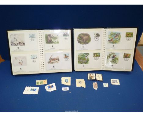 Two albums of WWF First Day covers and small quantity of loose stamps.