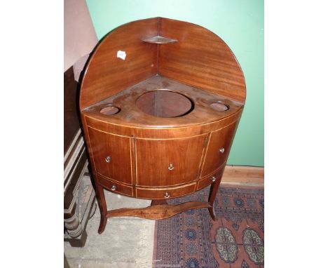 A Georgian Mahogany bow fronted Corner Washstand having boxwood beading, a central cupboard door and drawer below, three rece