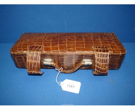 A crocodile skin effect vanity case and contents, bottles, brushes, mirror etc.