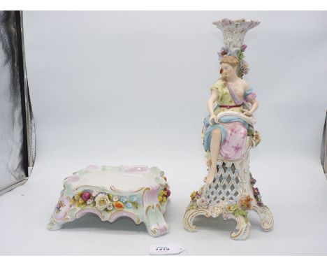 A large Potschappel (Carl Thiene) porcelain flower encrusted candlestick with porcelain figure of a lady perched on the side,