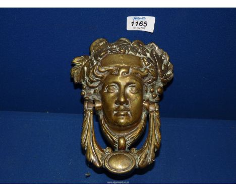 A brass Door knocker in the form of a Neo Classical head.