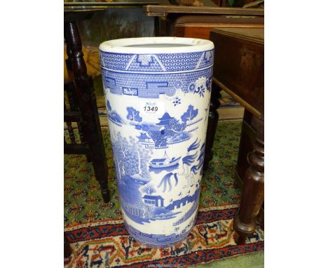A blue and white Willow pattern cylindrical stick stand, 18'' tall.