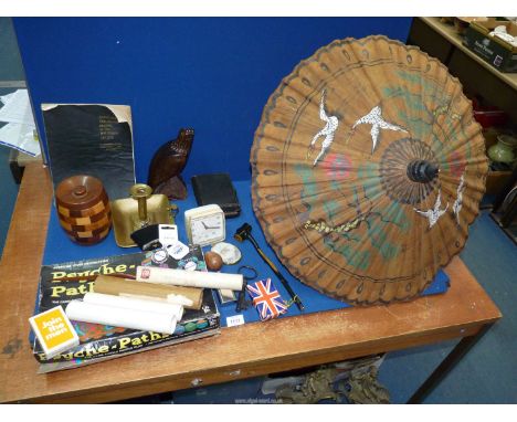 A box of miscellanea to include: games, hip flasks, various Treen biscuit barrel, carved eagle, 1950's alarm clock, brass cha