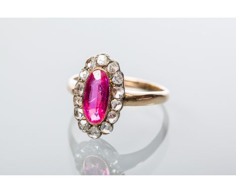 RUBY AND DIAMOND CLUSTER RING
with a central oval ruby surrounded by rose cut diamonds, in eighteen carat yellow gold, size Q