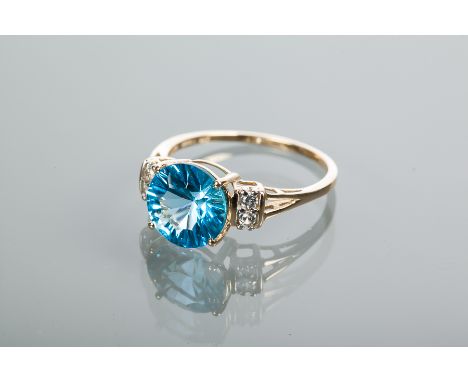 IMPRESSIVE TOPAZ DRESS RING
the large round blue topaz measuring approximately 10mm diameter, on bifurcated white gem set sho