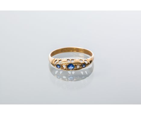 VICTORIAN EIGHTEEN CARAT GOLD SAPPHIRE AND DIAMOND RING
the boat shaped bezel set with three round sapphires alternated with 