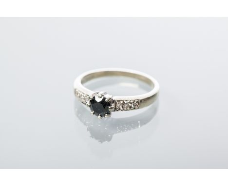 BLACK DIAMOND SOLITAIRE RING
with a central brilliant cut black diamond, on diamond shoulders, hallmarked nine carat white go