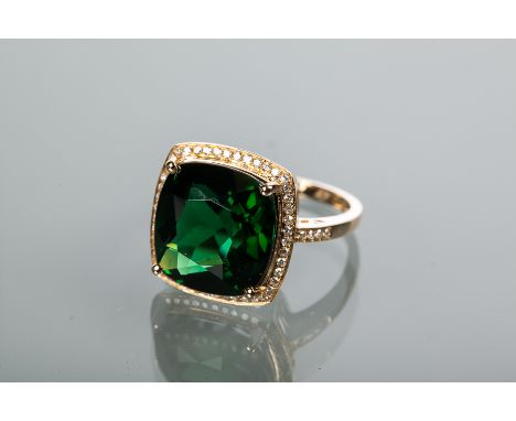 GREEN TOURMALINE AND DIAMOND CLUSTER RING
the central cushion cut green tourmaline approximately 8 carats, surrounded by bril