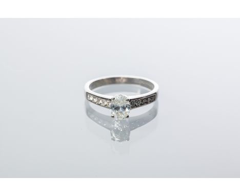 DIAMOND SOLITAIRE RING
the oval cut diamond approximately 0.7 carats, on diamond shoulders, in eighteen carat gold, size L-M