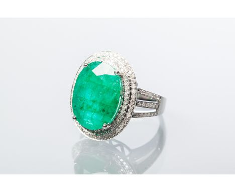 EMERALD AND DIAMOND CLUSTER RING
the central oval cut emerald approximately 8.0 carats, surrounded by diamonds totalling appr