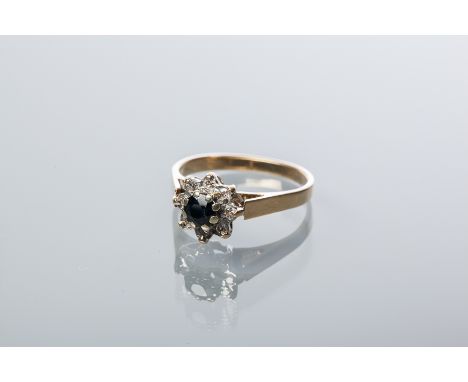 SAPPHIRE AND DIAMOND CLUSTER RING
with a central round sapphire surrounded by a row of brilliant cut diamonds, hallmarked nin