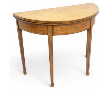 George III satinwood demi-lune tea table, fold-over top over double-gate leg action base, the central frieze rails and suppor