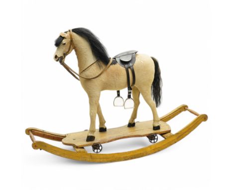 19th century pony skin pull-along rocking horse, pony skin covered wooden carved frame with glass eyes and leather bridle, on