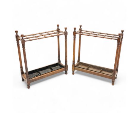 Pair of early 20th century mahogany hallway stick stands, rectangular form with open top forming twelve divisions, on ring tu