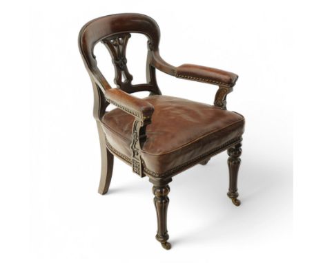 Victorian mahogany library elbow chair, arched cresting rail over shaped and pierced splat carved with cartouche, upholstered