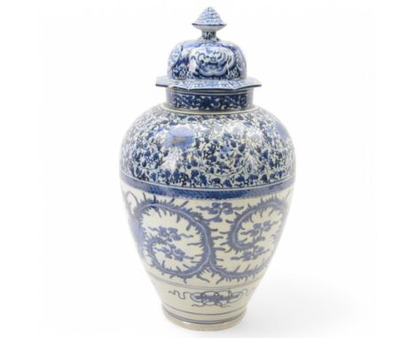 Large Japanese Arita blue and white jar and cover, the body of ovoid form decorated with flower heads and foliate tendrils, t
