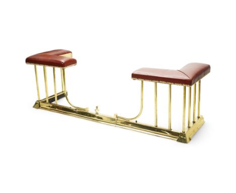 Brass telescopic fire fender, L-shaped corner seats upholstered in burgundy leather with brass stud work, plain balustrade ov