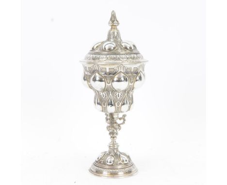 Late Victorian silver 'pineapple' chalice and cover, the tiered and dome moulded cup embossed and chased with stiff leaf and 