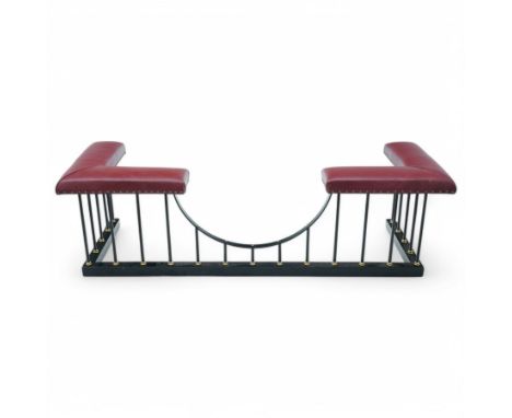 Wrought metal and brass fire fender, L-shaped corner seats upholstered in burgundy fabric with stud bands, dished centre on b