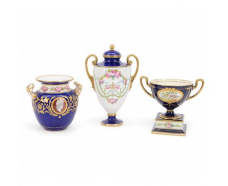 Early 20th century Minton porcelain twin handled pedestal cup, decorated with two reserve painted with birds against a blue g