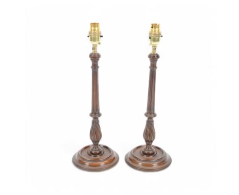 Pair of 19th century style mahogany candlestick table lamps, each with turned and fluted column, upon stepped circular base, 