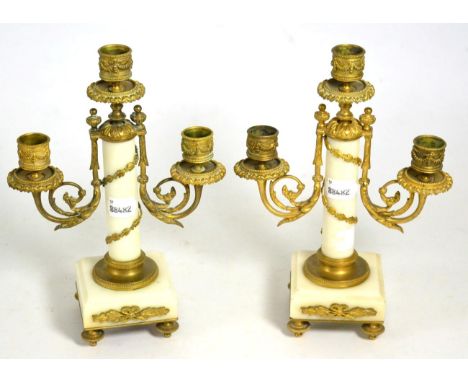 A pair of marble and gilt metal three light candelabra