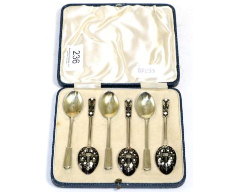 A cased set of six silver gilt and enamel coffee spoons