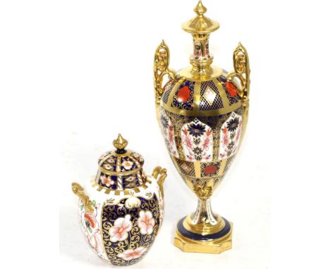 A Royal Crown Derby baluster vase and a two handled ovoid jar and cover Urn one - repaired cover and minor rubbing. Urn two -