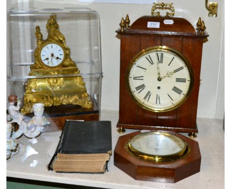 A French striking gilt metal mantel clock; an oak cased table timepiece; an inlaid mahogany anneroid barometer; and a copy of