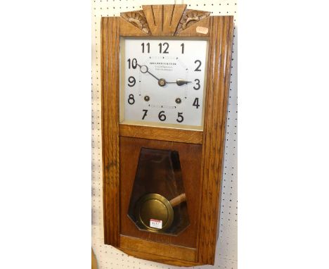 An Art Deco oak drop trunk wall clock, by Billard-Volteau, with pendulum and winding key, height 63.5cm