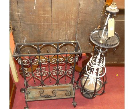 An early 20th century black painted wrought iron stickstand; together with a wrought iron floor light (2)