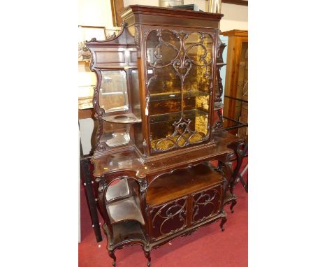 A circa 1900 Chippendale Revival floral carved mahogany breakfront side cabinet, of all over shaped form with recessed mirror