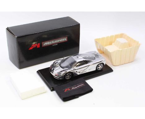 A Gwilo International boxed 1/18th scale model of a Mclaren Racing Car with chrome finish