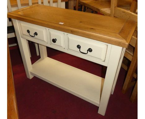 A contemporary light oak topped and painted two-tier three drawer hall table, w.106cm