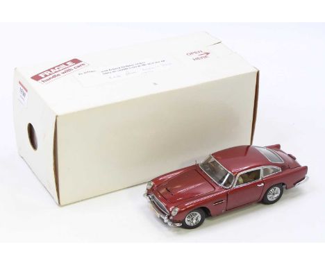 A Danbury Mint 1/24th scale Aston Martin DB5 in metallic maroon in the original box, model has been on display