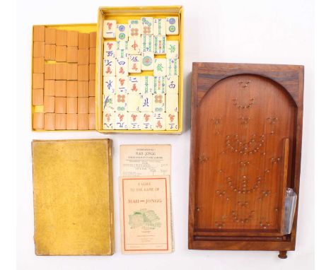 A boxed Mah-Jongg set with instructions together with a small wooden Bagatelle Board