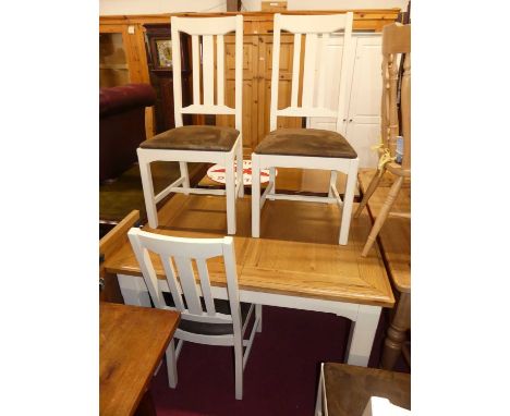 A contemporary light oak topped and painted dining table, having pull-out action and single extra drop-in leaf, max length 16