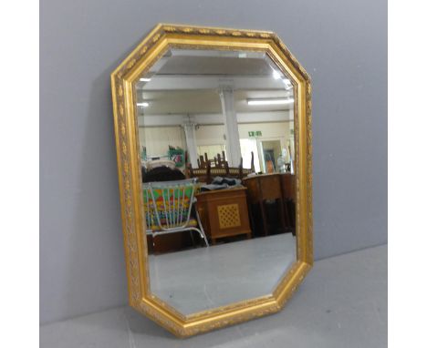 A modern octagonal bevel edged wall mirror in carved giltwood frame. Width 68cm, height 100cm.
