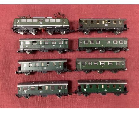 An N gauge German Bo-Bo electric locomotive in DB green, together with six Fleischmann four and six wheel coaches in matching