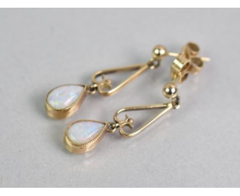 A Pair of Opal Drop Earrings, Pear Shape Cabochon Stones Measuring 8.1mm by 5.4mm, Bezel Set and Supported on a Yellow Metal 