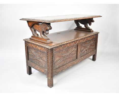 A Mid 20th Century Oak Monks Bench with Carved Panelled&nbsp; Decoration and Lion Supports, 107cms Wide