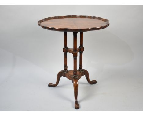 An Edwardian Walnut Tripod Table with Turned Supports and Piecrust Border