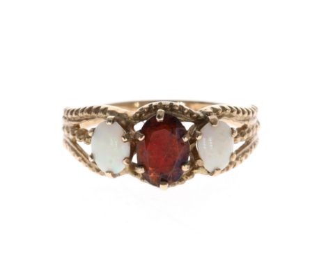 9ct gold Garnet and Opal trilogy dress ring. UK ring size L. Hallmarked on the inside of the band. Weighs in total 2.3g
