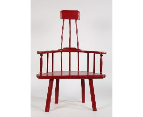 A 20th century Welsh style stick back elbow chair, painted in red, with solid shaped seat, raised on four chamfered legs, 128