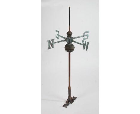 A weathervane, with the four points of the compass symbolised by capital letters, 109cm high, 59cm wide