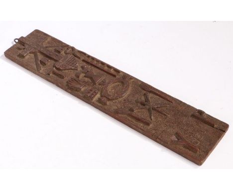 A Bolivian folk art carved panel, carved with a cross, heart, ladder, hand, cockerel and name "Y dela P", the reverse engrave